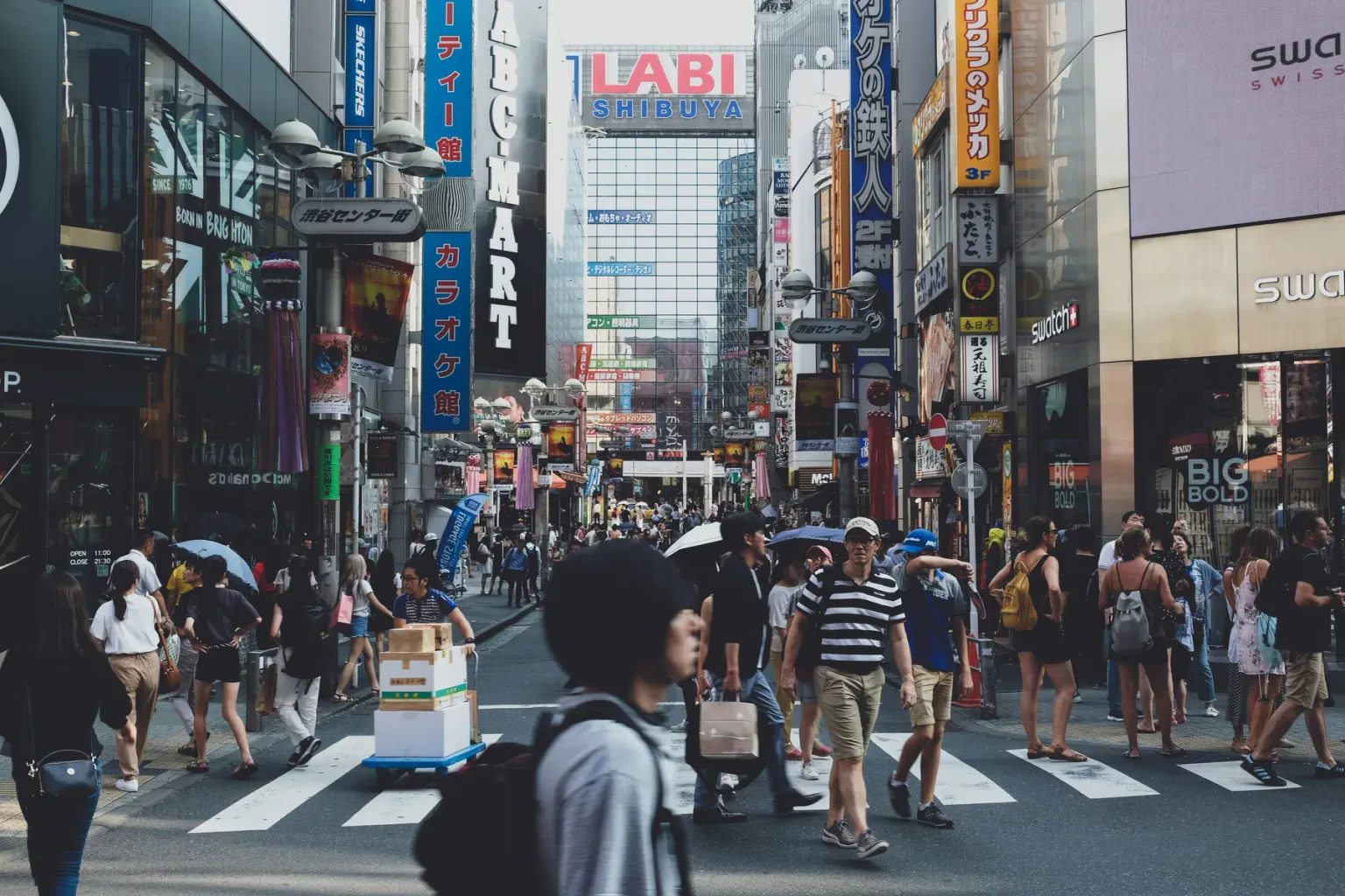 People walking through a busy commercial district in Tokyo