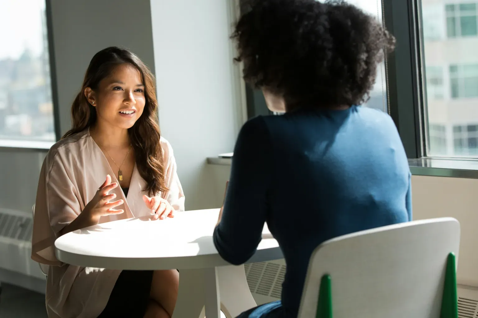 Researcher speaking with a participant across a table
