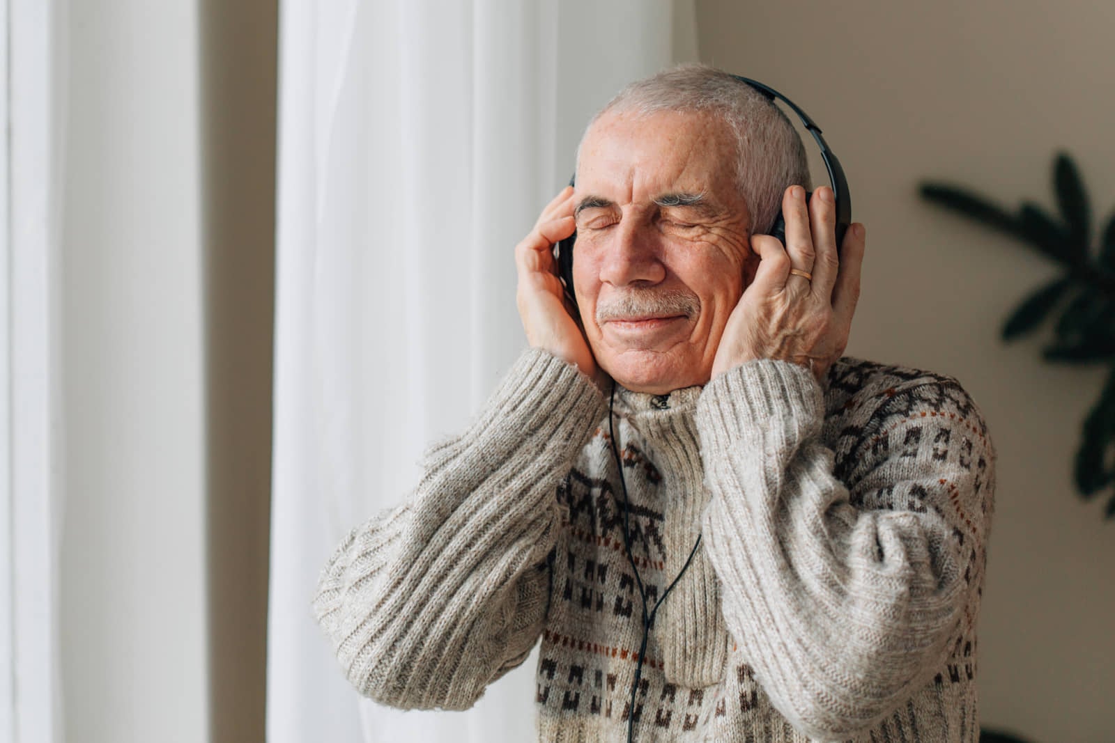 Older adult listening to music on headphones